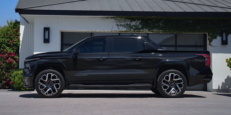 Side-Profile View Of The 2024 Silverado EV Parked In A Driveway