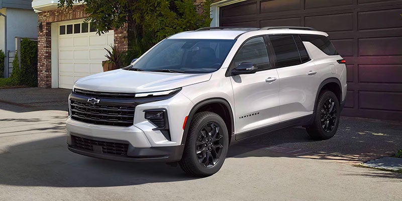 2024 Chevy Traverse parked in front of a garage