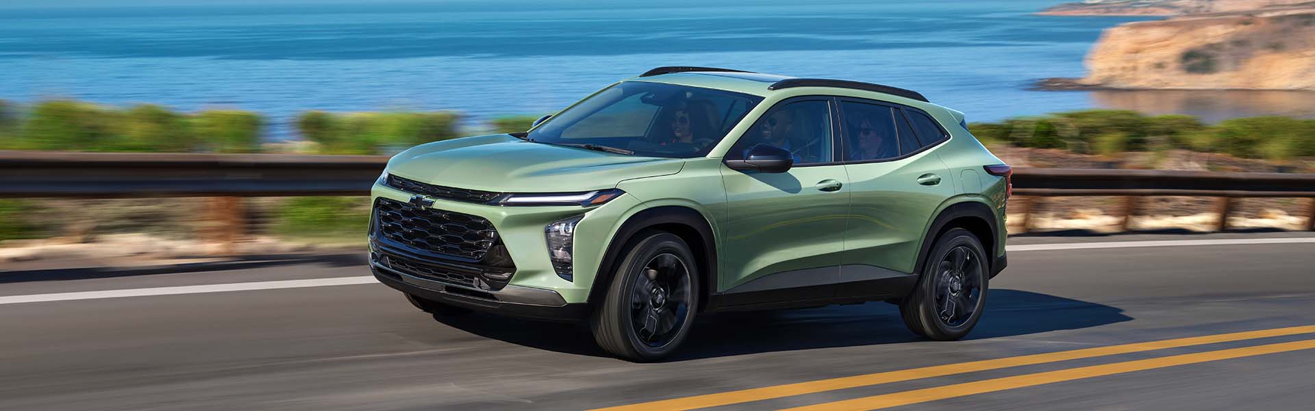 Chevy 2025 Trax Driving Swiftly on Waterfront Road