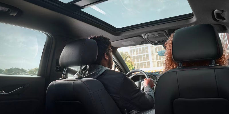 Rear View of a Man and Woman Sitting on the Front Seats of a Chevy Blazer