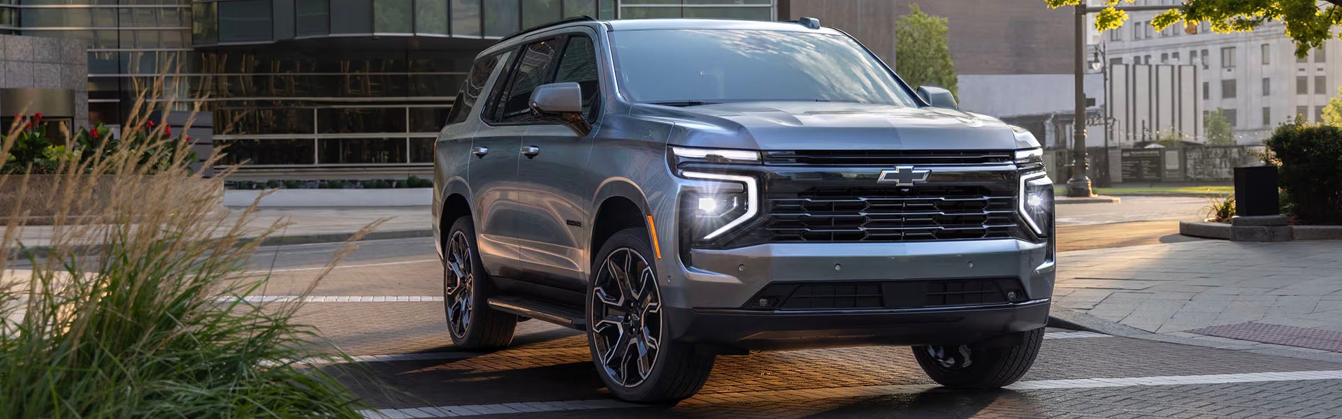 Front Three-quarters View of the 2025 Chevrolet Tahoe driving through a city street