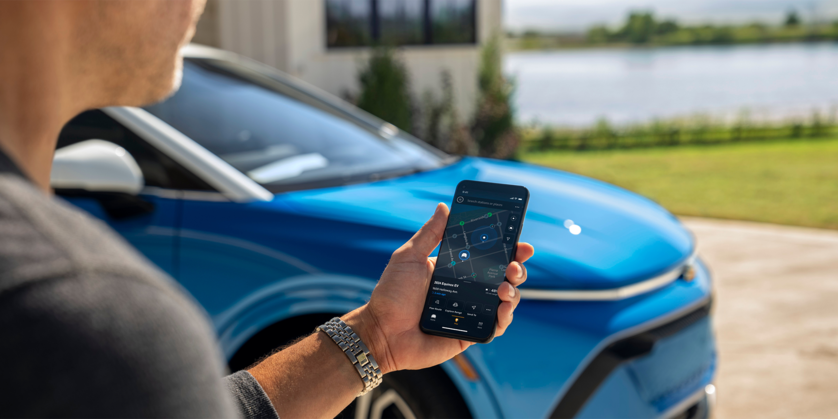 Image of Person Using the MyChevy App Near the 2024 Equinox EV