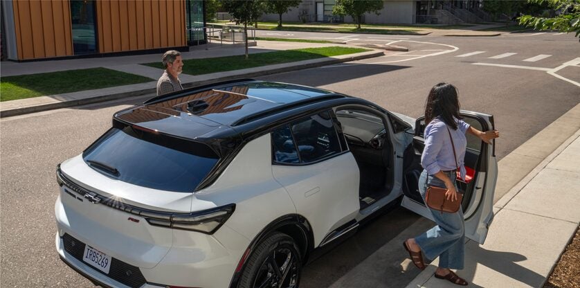 Image of Woman Exiting a Parked 2024 Chevy Equinox EV