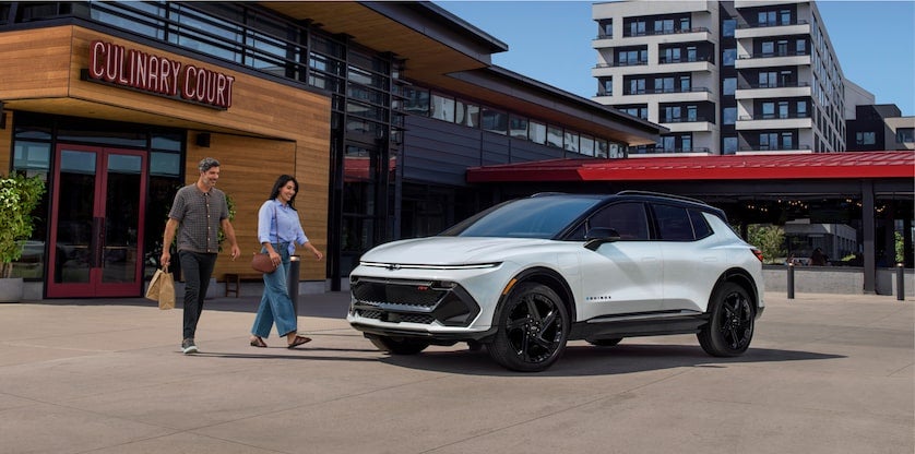 2024 Equinox EV 3RS in Summit White with Mosaic Black Metallic Roof Parked in the City