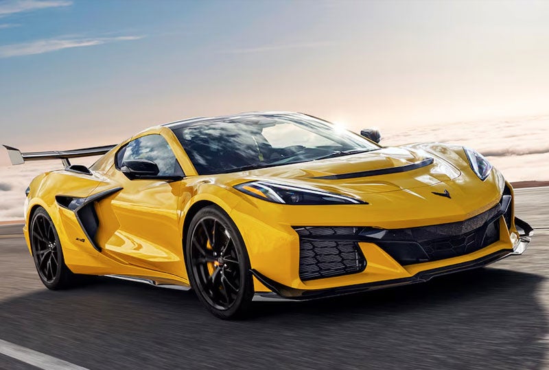 Three Quarter View of a Yellow Chevy Corvette ZR1 Going down a Road on a Sunny Day