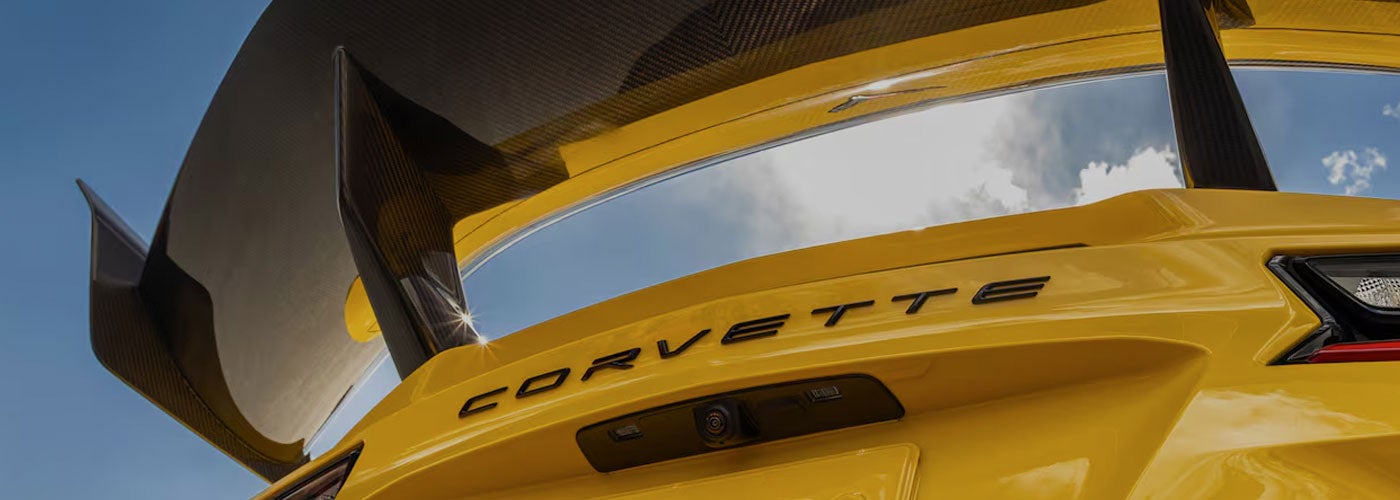 Low Angle Shot from under the Rear Tail of a Yellow Chevy Corvette ZR1 with a Blue Sky Above
